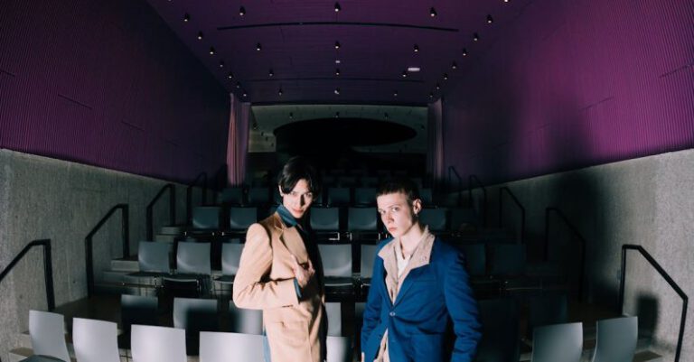 Czech Cinema - A couple standing in a room with chairs